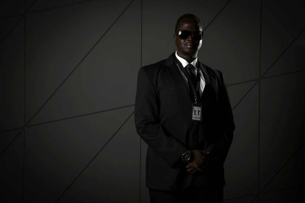 man in black suit wearing black sunglasses